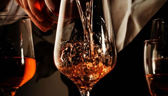 sommelier-pouring-rose-wine-into-glass-at-wine-tas